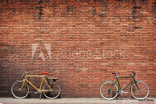 Picture of Retro bicycle on roadside with vintage brick wall background